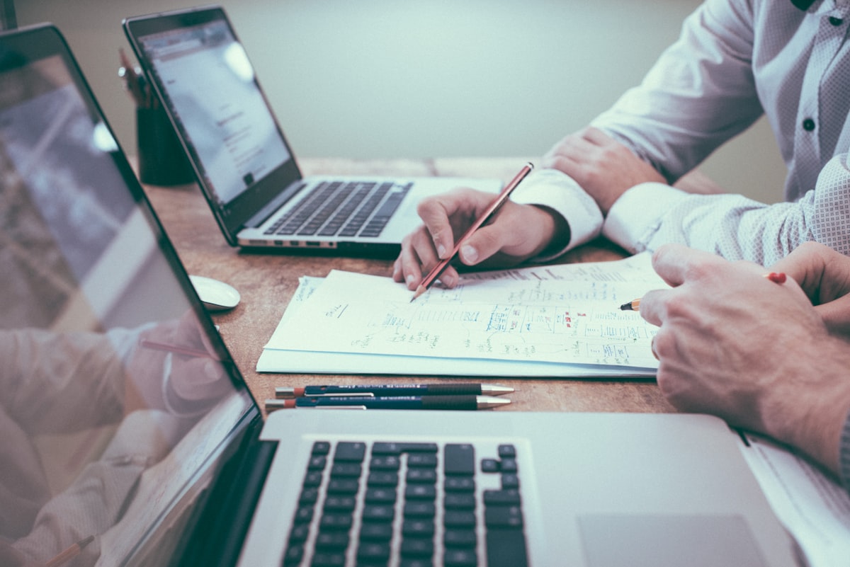 Person planning their financial future at a desk with notes and laptop